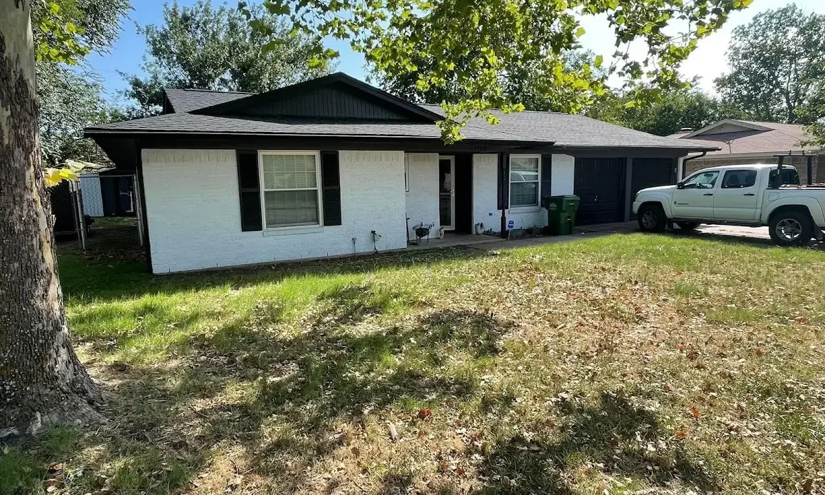 Professional roofing crew working on a residential roof in Greenwood